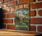 A vintage-style metal sign for the Dillard Mill Historic Site in Missouri, featuring an illustration of a mill and a river.