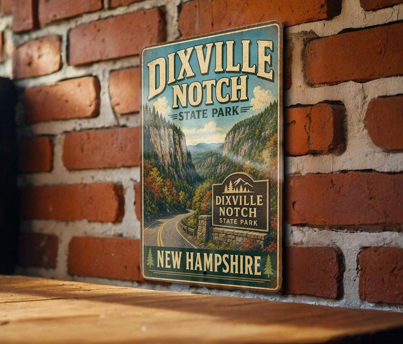A vintage-style metal sign for Dixville Notch State Park in New Hampshire, featuring a scenic mountain landscape.