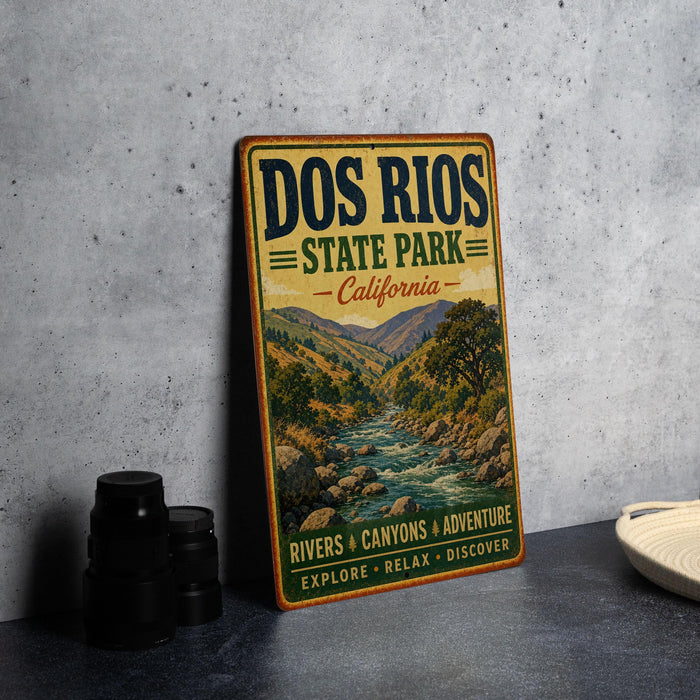 A vintage-style metal sign for the state park, displaying the name "Dos Rios State Park, California" and the slogan "Rivers & Canyons & Adventure Explore Relax Discover".