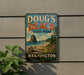 A vintage-style metal sign for Doug's Beach State Park in Washington, featuring a scenic landscape with a mountain, beach, and pine trees.