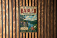 A vintage metal sign for Dr. Edmund A. Babler Memorial State Park in Missouri, featuring a scenic landscape with a lake and mountains.