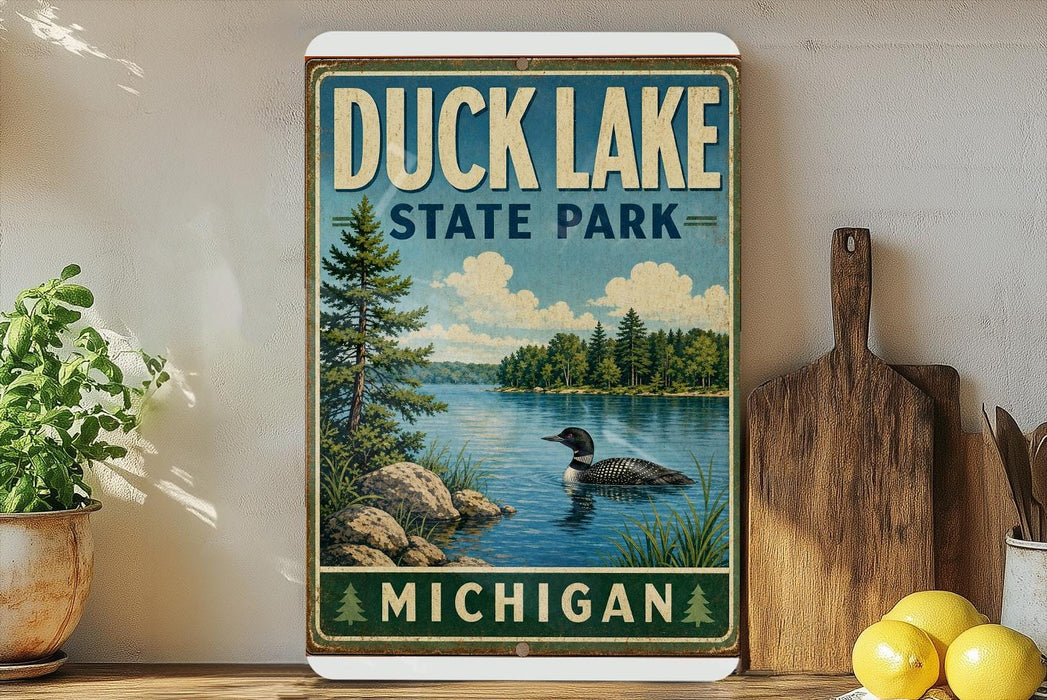 A vintage-style sign for Duck Lake State Park in Michigan, featuring a lake scene with a loon and trees in the background.
