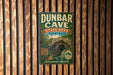 A vintage-style metal sign for Dunbar Cave State Park in Tennessee, featuring a cave illustration and the text "DUNBAR CAVE STATE PARK TENNESSEE" and "ADVENTURE AVENUES".