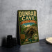 A vintage-style metal sign for Dunbar Cave State Park, Tennessee, featuring a scenic illustration of the cave and the text "Adventure Awaits".