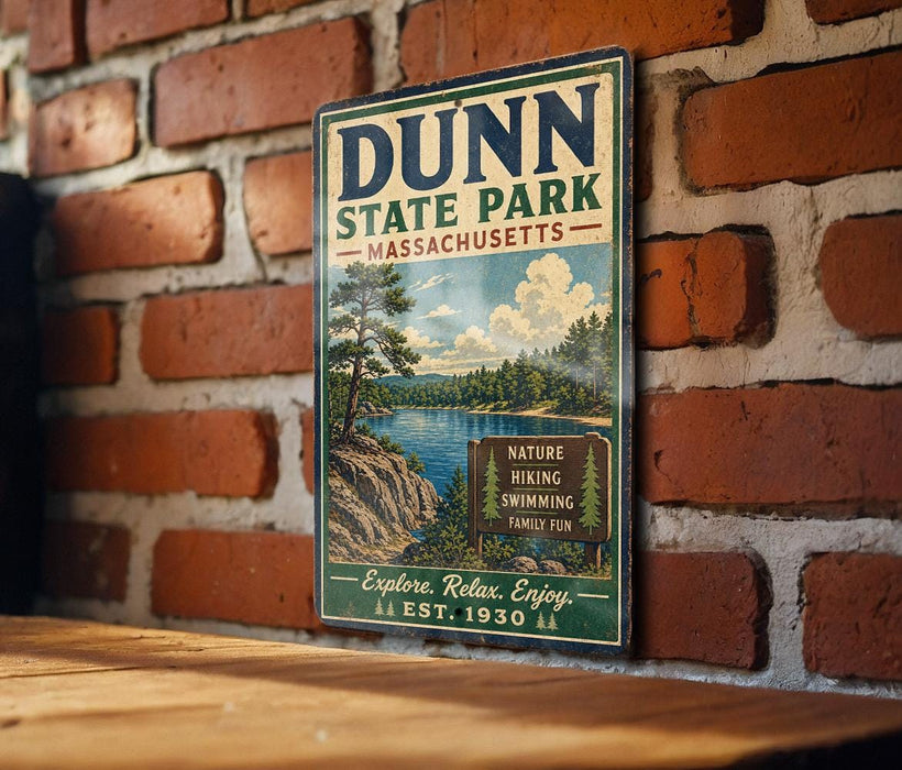 A vintage-style metal sign for Dunn State Park in Massachusetts, featuring a scenic landscape with a lake and mountains.
