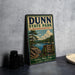 A vintage metal sign for Dunn State Park in Massachusetts, featuring a scenic landscape with a lake and pine trees.