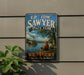 A vintage-style sign for E.P. Sawyer State Park in Kentucky, featuring two men fishing in a river with a steamboat in the background.