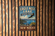 A vintage-style sign for Eagle Nest Lake State Park in New Mexico, featuring an eagle in flight and a scenic landscape.