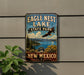 A vintage-style sign for Eagle Nest Lake State Park in New Mexico, featuring a scenic landscape with mountains, trees, and a bird in flight.
