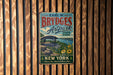 A vintage-style metal sign for "Earl W. Brydges Artpark" in New York, featuring a scenic landscape with a bridge and flowers.