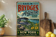 A vintage-style sign for "Brydges Artpark" in New York, featuring a scenic view of the park and a bridge.