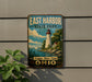 A vintage-style sign for East Harbor State Park in Ohio, featuring a lighthouse and a scenic landscape.