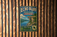 A vintage-style metal sign for Echo Bluff State Park in Missouri, featuring a scenic landscape with a cliff overlooking a lake.