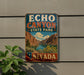A vintage-style sign for Echo Canyon State Park in Nevada, featuring a scenic landscape with mountains, a river, and desert vegetation.