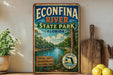 A vintage-style sign for Econfina River State Park in Florida, featuring a scenic illustration of the river surrounded by lush greenery.