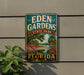 A vintage-style sign for Eden Gardens State Park in Florida, featuring a scenic illustration of a bridge, palm trees, and flowers.