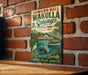 A vintage-style sign for Edward Ball Wakulla Springs, Florida, featuring a manatee, palm trees, and a building in the background.