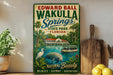 A vintage-style sign for Edward Ball Wakulla Springs State Park, Florida, featuring illustrations of a manatee, a boat, and a tropical landscape.