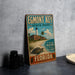 A vintage metal sign for Egmont Key State Park in Florida, featuring a lighthouse and beach scene.