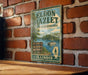 A vintage metal sign for the El donkey Hazellet State Recreation Area in Illinois, featuring a scenic image of a lake and surrounding landscape.