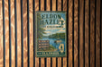 A vintage metal sign for Eldon Hazzlet State Recreation Area in Illinois, featuring a scenic image of a lake and surrounding landscape.