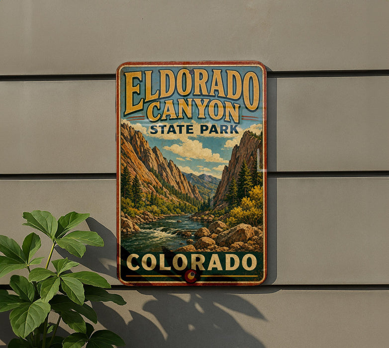 A vintage-style sign for Eldorado Canyon State Park in Colorado, featuring a scenic mountain landscape with a river and pine trees.