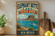 A vintage-style sign for Elephant Butte Lake, New Mexico, featuring a scenic image of a mountain, lake, and boat.