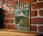 A vintage-style metal sign for Elijah Bristow State Park in Oregon, featuring a mountain landscape with a waterfall and pine trees.