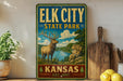 A vintage-style sign for Elk City State Park in Kansas, featuring an illustration of a deer in a scenic landscape.