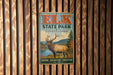 A vintage metal sign for Elk State Park in Pennsylvania, featuring an illustration of a deer with antlers and a scenic landscape.