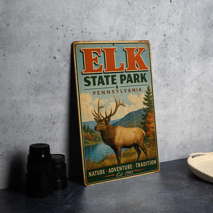 A vintage-style metal sign for the Elk State Park in Pennsylvania, featuring an illustration of a deer with antlers and a scenic landscape.