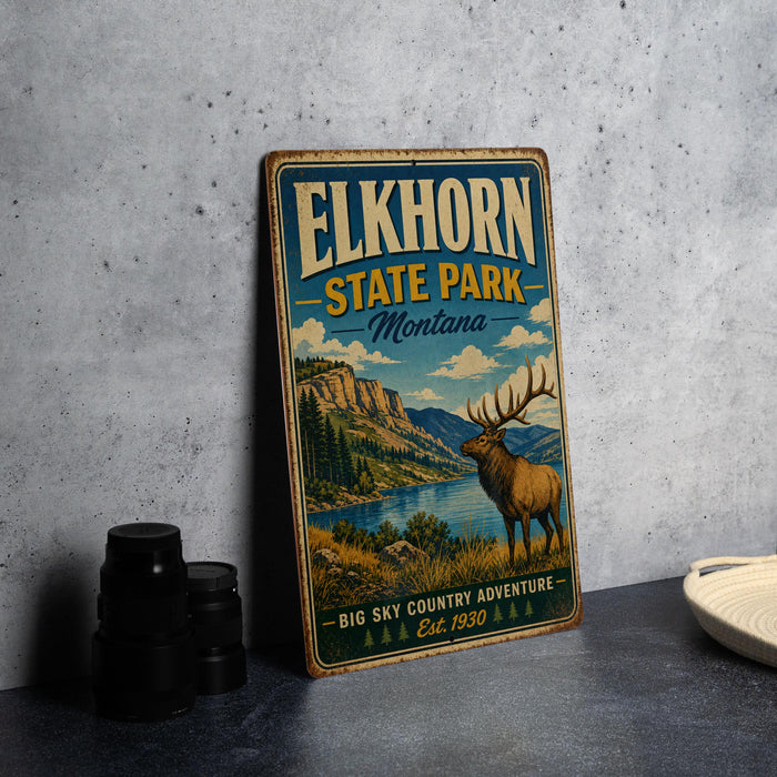A vintage-style metal sign for Elkhorn State Park, Montana, featuring an illustration of a deer in a mountainous landscape.