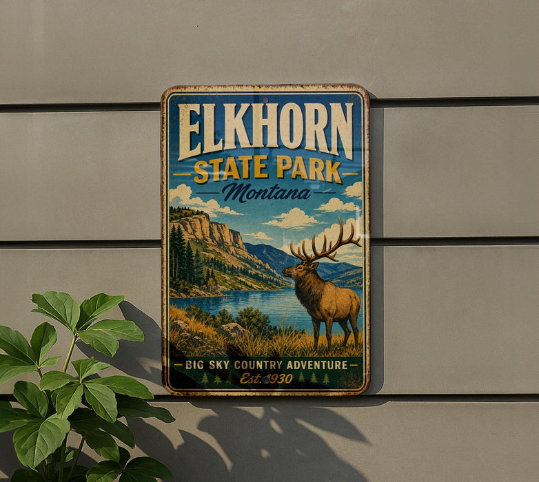 A vintage-style metal sign for Elkhorn State Park in Montana, featuring an illustration of a large elk standing in a scenic landscape with mountains, water, and trees.