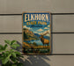 A vintage-style metal sign for Elkhorn State Park in Montana, featuring an illustration of a large elk standing in a scenic landscape with mountains, water, and trees.