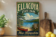 A vintage-style metal sign for Ellacoya State Park in New Hampshire, featuring a scenic image of a lake, mountains, and a red canoe.