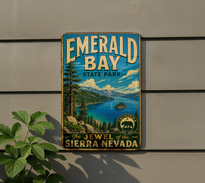 A vintage-style sign for Emerald Bay State Park, featuring a scenic landscape with mountains, a lake, and pine trees.