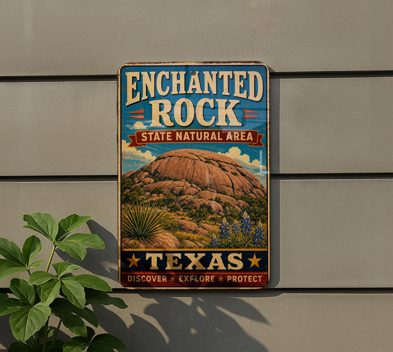 A vintage-style metal sign for the Enchanted Rock State Natural Area in Texas, featuring a scenic illustration of the rock formation and desert landscape.