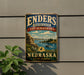 A vintage metal sign for the Enders Reservoir State Recreation Area in Nebraska, featuring a scenic landscape with a lake, mountains, and a boat.