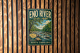 A vintage metal sign for Eno River State Park in North Carolina, featuring a scenic illustration of a river surrounded by trees and mountains.