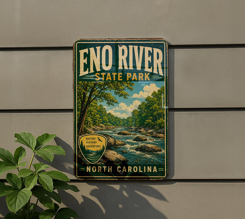 A vintage-style metal sign for Eno River State Park in North Carolina, featuring a scenic illustration of a river surrounded by trees and rocks.