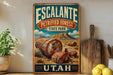 A vintage-style metal sign for Escalante Petrified Forest State Park in Utah, featuring a desert landscape with petrified trees and mountains.
