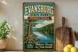 A vintage-style sign for Evansburg State Park in Pennsylvania, featuring a scenic image of a river and forest.