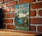 A vintage metal sign for F.D. Roosevelt State Park in Georgia, featuring a scenic landscape with a lake and mountains.