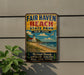 A vintage-style metal sign for Fair Haven Beach State Park in New York, featuring a lighthouse, beach, and ocean scenery.