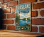 A vintage-style metal sign for Falls Lake, North Carolina, featuring a scenic image of the lake with a sailboat and a dock.