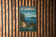 A vintage-style metal sign for Fay Babinbridge State Park, featuring a scenic image of the park, a boat on the water, and a mountain in the background.