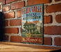 A vintage-style metal sign for the Felix Valle House, a historic site in Missouri, is displayed on a brick wall.