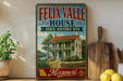 A vintage-style metal sign for the Felix Valle House, a historic site in Missouri, with a picture of the house and surrounding landscape.