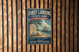a vintage-style metal sign for First Landing State Park, Virginia, mounted on a wooden wall.
