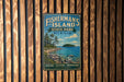 A vintage-style metal sign for Fisherman's Island State Park in Michigan, featuring a scenic image of the island and its surrounding landscape.